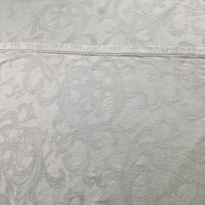 an image of a close up of a bed with a white comforter
