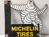 a sign that says michel tires with a picture of a man in the middle of it