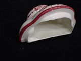 a white and red shoe shaped object on a black surface