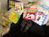 a pile of children ' s books and books on a bed