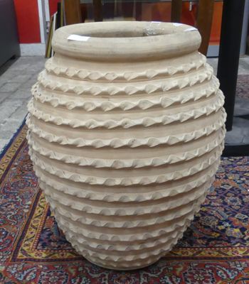 a large vase sitting on a rug on the floor