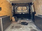 the inside of a van with the door open and the floor in the back
