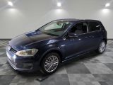 the blue volkswagen golf is parked on a checkered tile floor