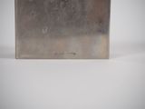 a metal box with a picture on it on a white surface