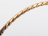 a close up of a gold rope with a white background