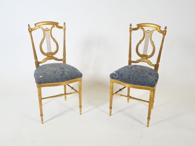 pair of chairs with a blue upholstered seat and a gold frame