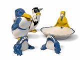 three figurines of birds sitting next to each other