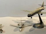 three model airplanes that are on display on a table