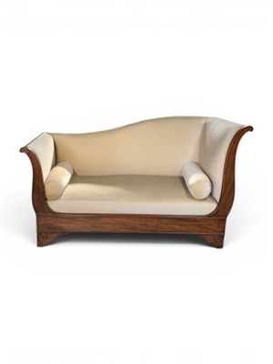 an image of a wooden couch with a beige upholstered cushion
