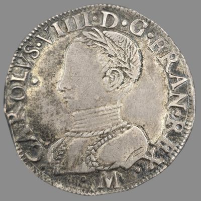 Gros plan sur une pièce d'argent portant une tête d'homme