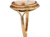 a close up of a gold ring with a stone in the center