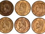 a close up of six different types of coins on a white background