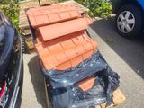 a pile of bricks sitting on a pallet next to a car