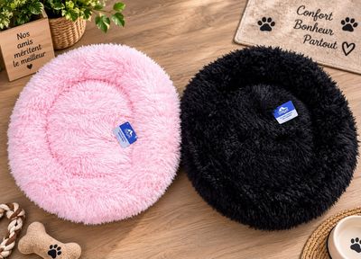 two dog beds on a table with a dog bone