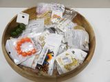 a wooden bowl filled with assorted items on a table