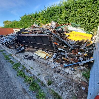 a pile of junk sitting on the side of the road