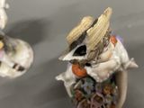 two figurines that are sitting on a table