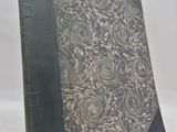 a close up of a book on a table with a white background