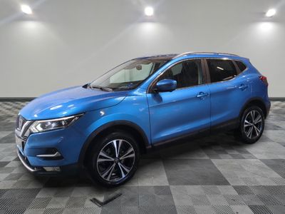 a blue nissan suv parked on a checkered tile floor