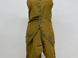 an image of a mannequin on a wooden stand with a white wall in the background
