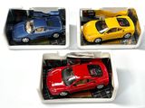 trois petites voitures posées dans une boîte sur une table