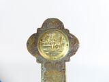 a gold cross with a picture of a man and a woman on it
