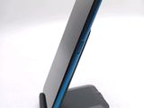 a cell phone sitting on a stand on a white surface