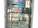a glass display case with a blue bus in the background