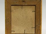 an old wooden picture frame sitting on top of a white surface