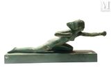 statue of a woman laying on her back on a marble base