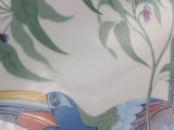 a colorful vase with a bird painted on it