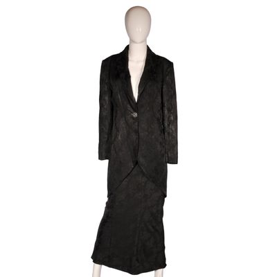 an image of a mannequin wearing a black coat and skirt