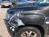 a car that has been badly damaged and is parked in a parking lot