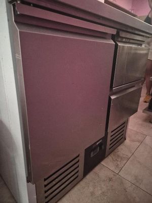 a purple refrigerator sitting in a kitchen next to a stove