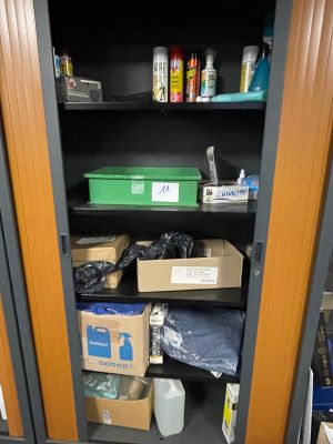 a cupboard with many boxes and other items in it