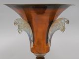 a brown vase with a lion head on it