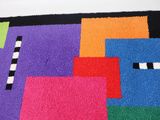 a colorful rug with squares of different colors on it
