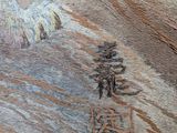 a close up of a painting of a bird on a wooden surface
