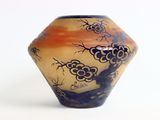 a vase that has a picture of a tree on it