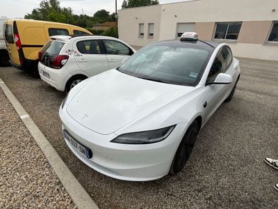 une Tesla Model S blanche garée sur un parking