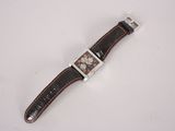 a close up of a watch on a white surface with a white background