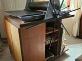 a television that is on top of a wooden cabinet