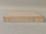 books are stacked on top of each other on a white surface