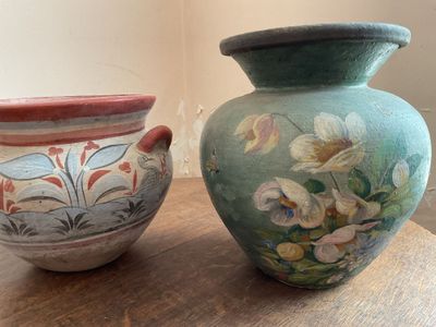two vases that are sitting on a wooden table