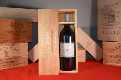 a bottle of red wine in a wooden box