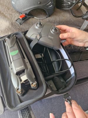 a person that is holding a remote control in a bag