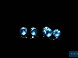 three blue diamonds in the dark on a black background