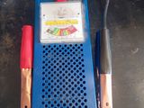 a blue and red battery charger on a table
