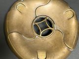a gold object with a black center on a table