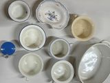 a lot of dishes and cups that are sitting on a table